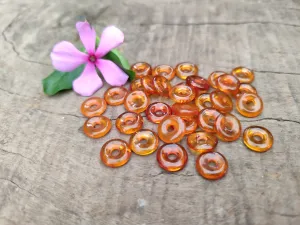 Polished Box of Fossilized Baltic Amber Donut Rings for Pendants x 39 From Poland